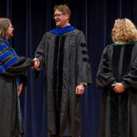 Awardee shaking Christine's hand